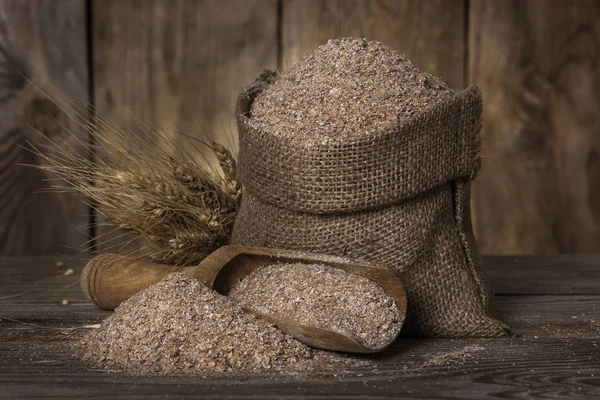 Wheat bran in a bag — Stock Photo, Image