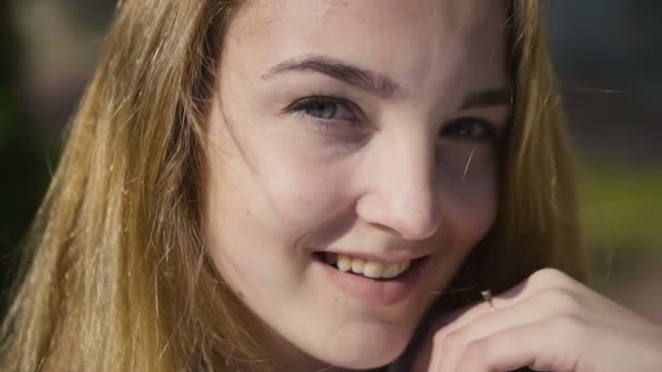 Close-up Portrait of a Young Blonde Smiling Girl — Stock video