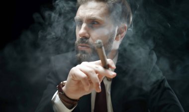 Sigara içen sakallı adam, yakın plan.