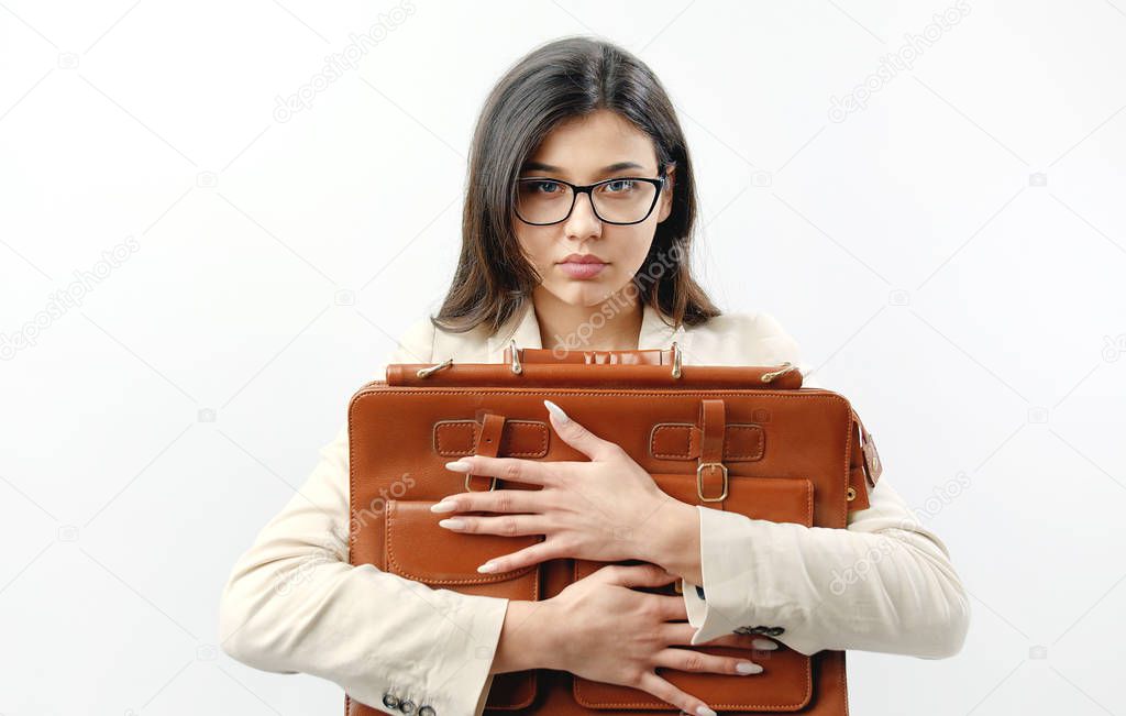Serious woman embracing handbag