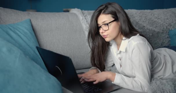 Serious lady typing on computer at home — 비디오