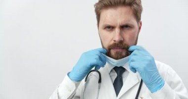 Doctor in medical clothing, rubber gloves and mask