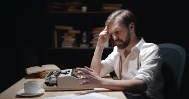 Thoughtful Writer Sitting at Typewriter