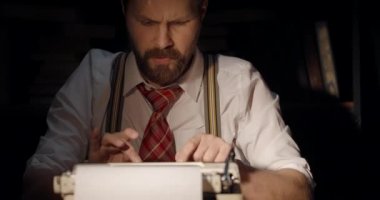 Male Writer Reading Typed Page