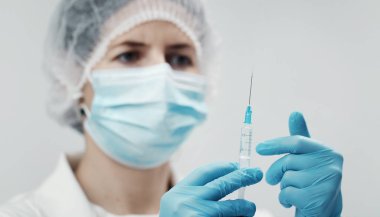 Doctor removing air from syringe