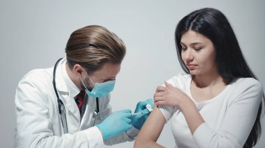 Doctor giving vaccination to patient
