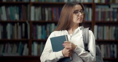 Portrait of Successful Female Student in Library