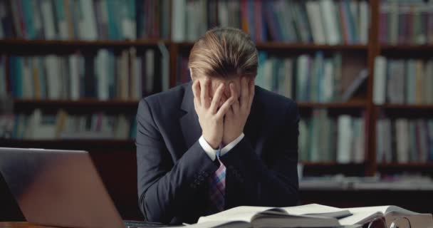 Thoughtful Man with Laptop in Library — Stockvideo