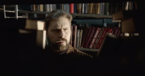 Bearded Man in Library Taking Book — Stock Video