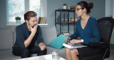 Psychologist working with bearded patient at office