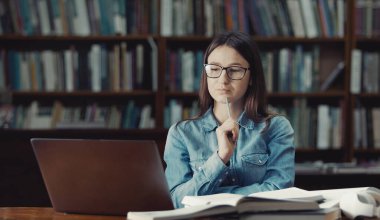 Pensive student looks computer screen
