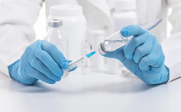 Doctor fills syringe