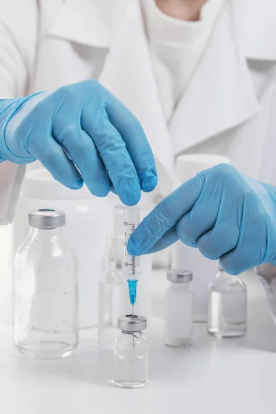 Doctor fills syringe