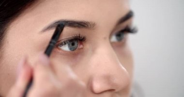 Woman Making Brows Makeup Closeup
