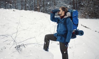 Backpacker looking through binocular