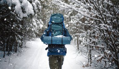Outdoorsman walking on forest path