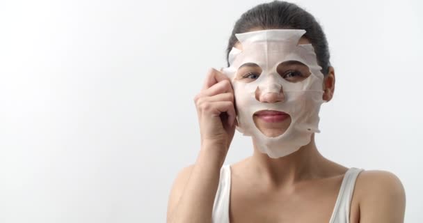 Portrait of cheerful woman taking off fabric face mask — Stock Video