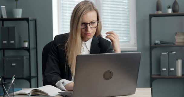 Gericht zakenvrouw zitten aan tafel met laptop — Stockvideo