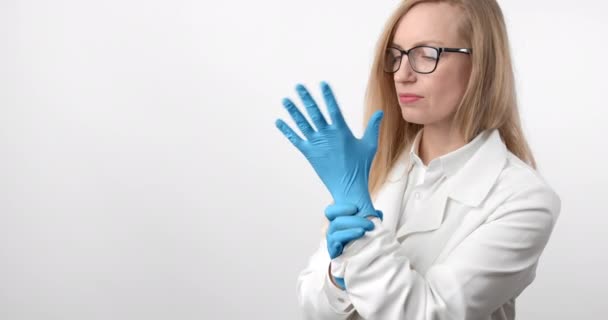 Portrait of female doctor wearing lab coat and rubber gloves — Stock Video