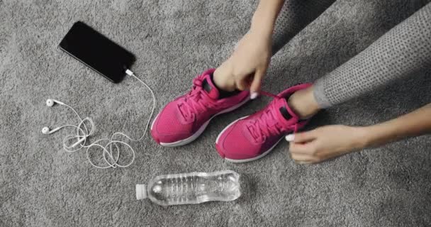 Närbild av kvinnliga händer binda snören på sport sneakers — Stockvideo
