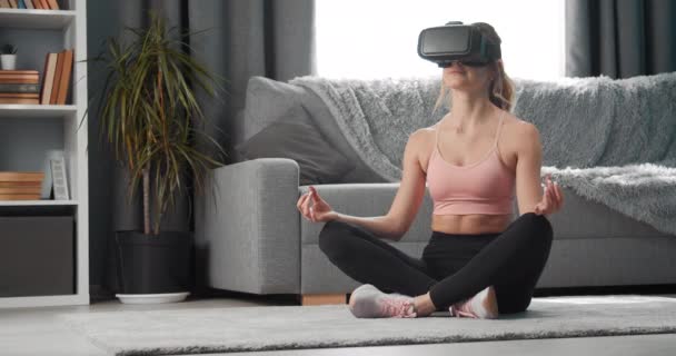 Beautiful woman in virtual glasses doing yoga exercise — Stock Video