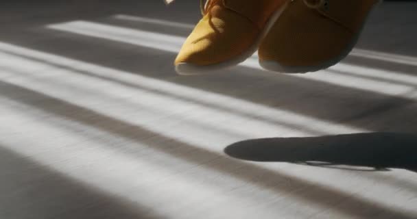 Close up of young girl in sneakers jumping with rope — Stock Video