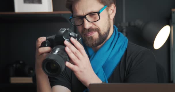 Cheerful photographer reviewing photos on camera — Stock Video