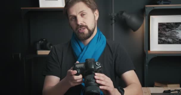 Bearded blogger recording video review of new digital camera — Stock Video