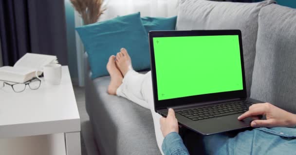 Close up of woman using laptop with chroma key screen — Stock Video