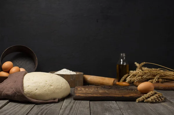 Тесто с ингредиентами для приготовления теста на деревянном кухонном столе — стоковое фото