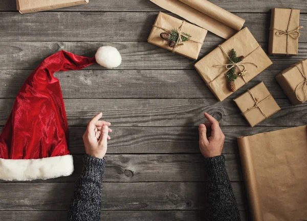 크리스마스 선물 산타 모자와 남자 손 — 스톡 사진