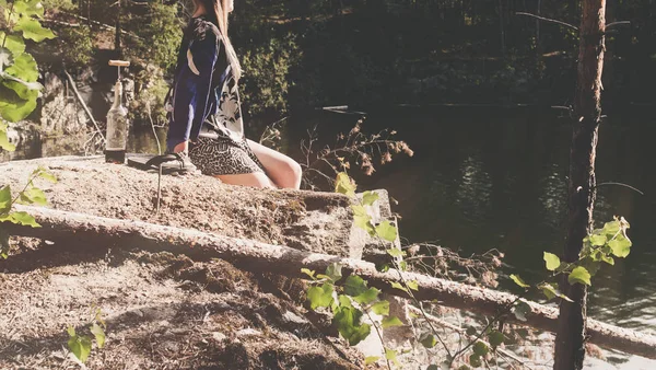 Žena sedí na skále a užijte si chvíle relaxace — Stock fotografie