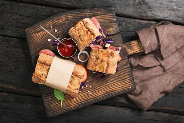 Сэндвич с мясом говядины на деревянной доске — стоковое фото