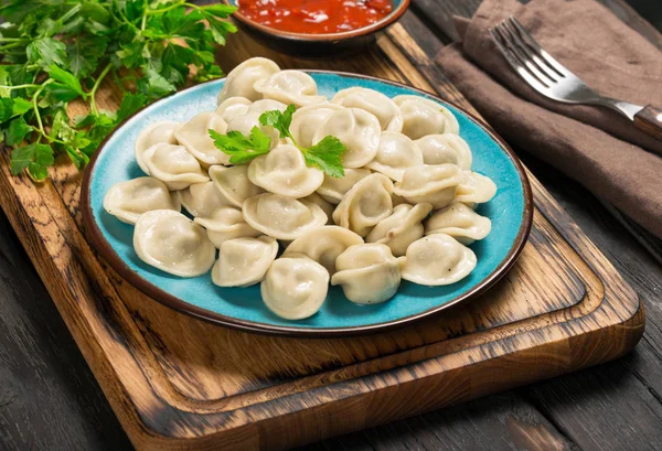 Dumplings with meat close up with sauce and parsley — Stock Photo, Image