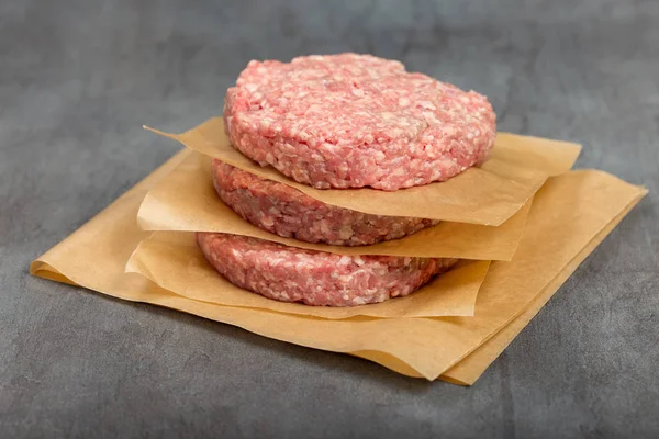 Hamburger meat on the grey background close up — Stock Photo, Image