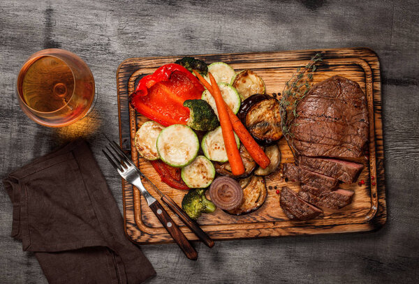 Steak grilled with vegetables grilled and glass of cognac