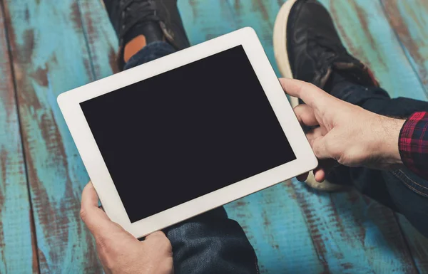 Man holding digital tablet with copy space while sitting — Stock Photo, Image