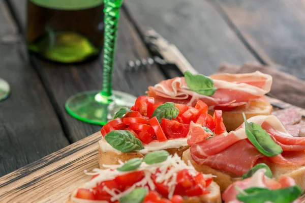 Various Italian appetizers for wine on wooden board — Stock Photo, Image