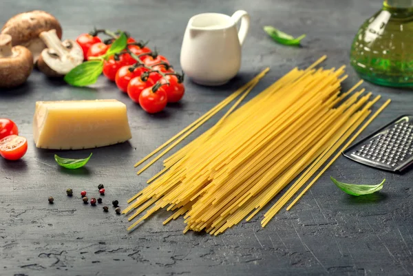 Italian raw pasta with set of ingredients for cooking pasta