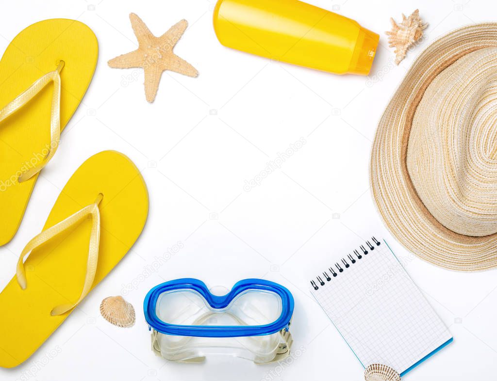 Frame of beach accessories on white background
