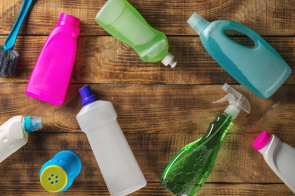 Cleaning product on wooden background, top view