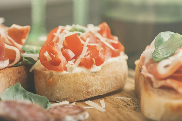 Bruschetta with tomato, parmesan cheese and basil — Stock Photo, Image