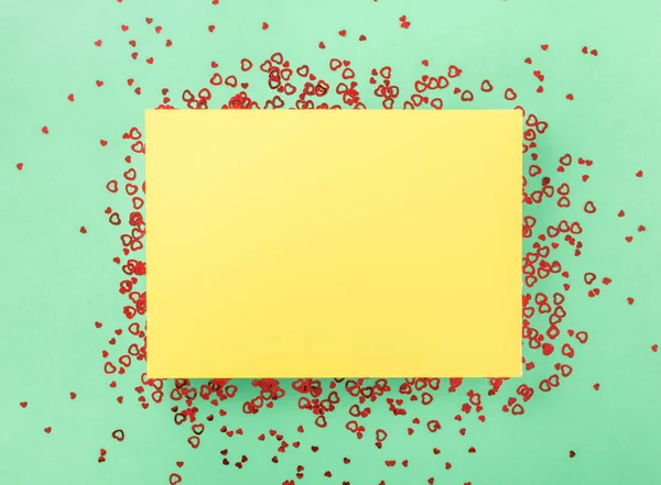 Gelbe Karte mit kleinen roten Herzen — Stockfoto