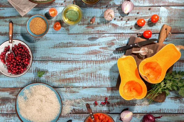 Ingredients for preparation baked squash on wooden table