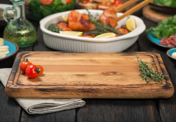 Cutting board on wooden table with free place for you — Stock Photo, Image