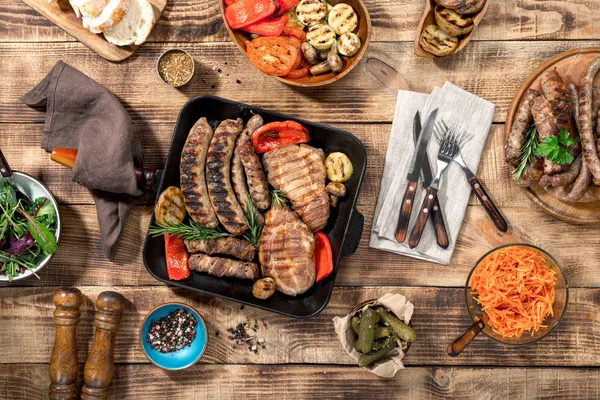 Bistecca alla griglia, salsicce alla griglia, verdure alla griglia sul legno — Foto Stock