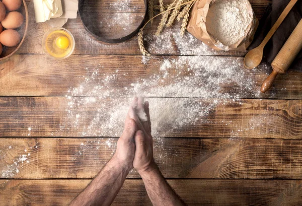 Ο άνθρωπος προετοιμάζει ζύμη ψωμιού ξύλινο τραπέζι στο φούρνο — Φωτογραφία Αρχείου