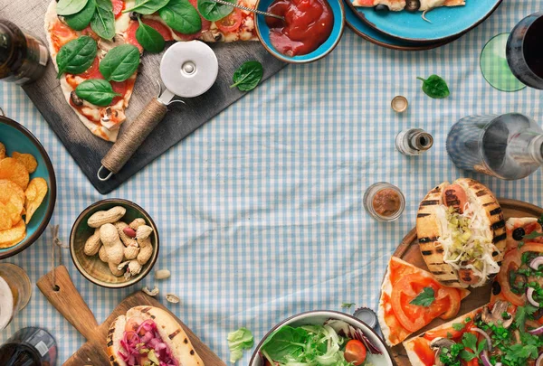 Frame of pizza, hot dog, salad, wine, lager, snacks — Stock Photo, Image