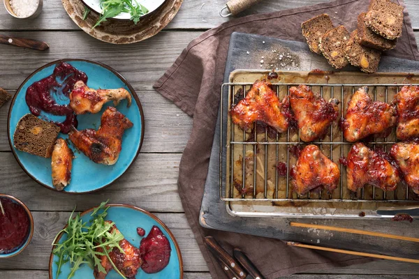 Dinner table with chicken wings — Stock Photo, Image