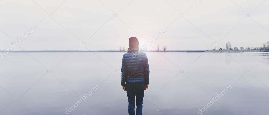 Woman standing with back on the river